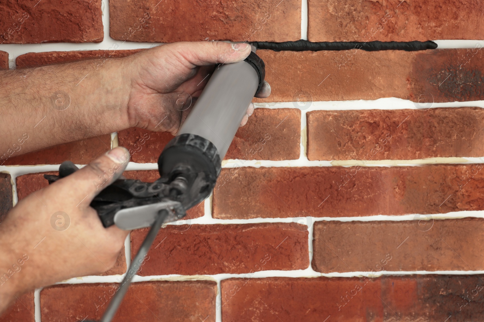 Photo of Professional builder using tiling fugue for grouting, closeup