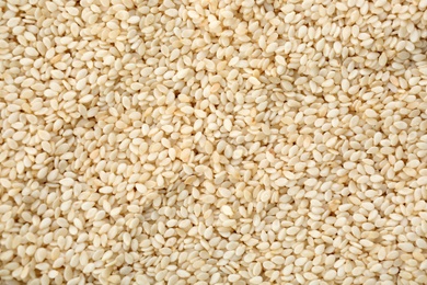 Pile of white sesame seeds as background, top view