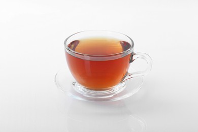 Photo of Tasty tea in cup on white background