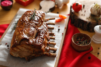 Delicious roasted ribs served on wooden table