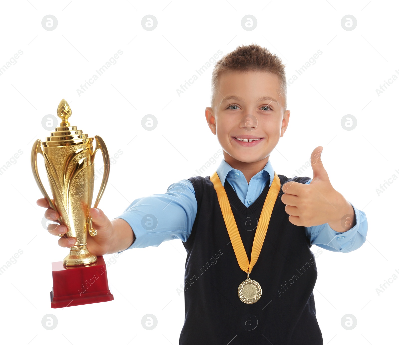 Photo of Happy boy in school uniform with golden winning cup and medal isolated on white