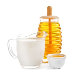 Photo of Jug of milk and honey on white background