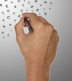 Image of Man writing letters and they flying away on grey gradient background, closeup