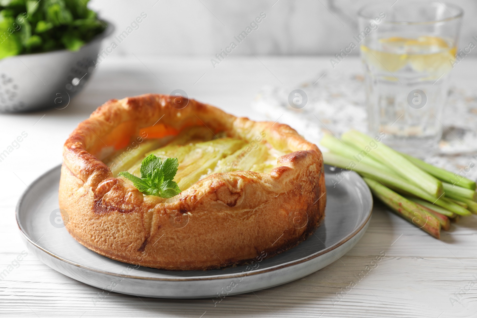 Photo of Freshly baked rhubarb pie on white wooden table