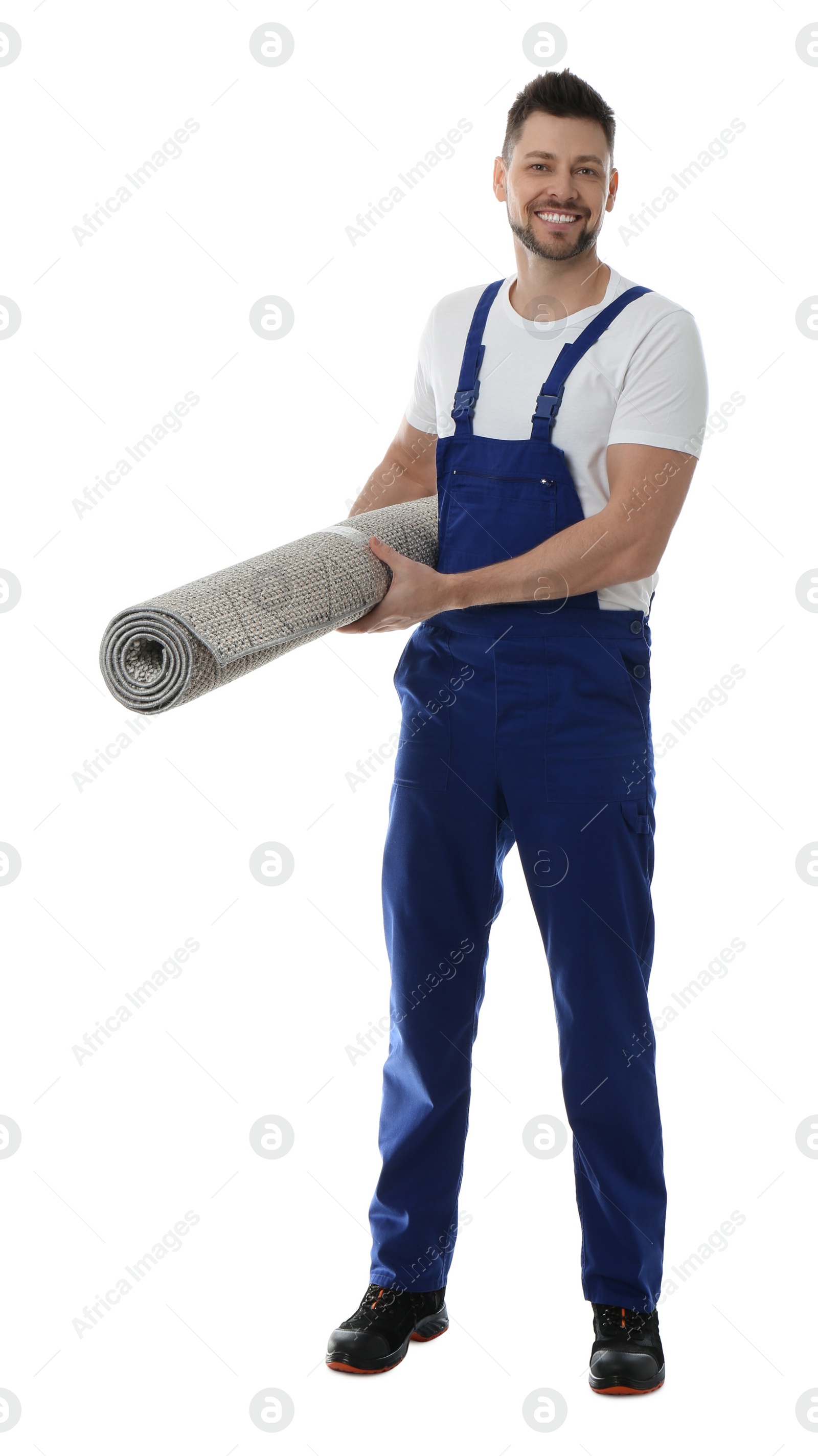 Photo of Male worker with rolled carpet on white background