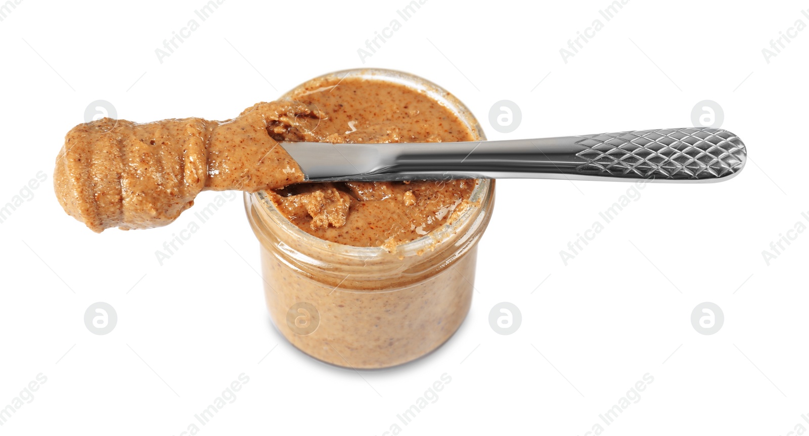 Photo of Delicious nut butter in jar and knife isolated on white