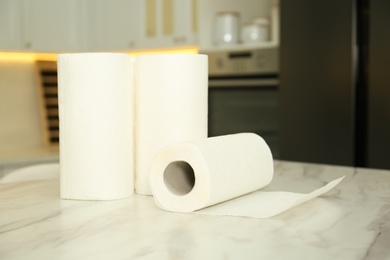 Photo of Paper towels on white marble table in kitchen