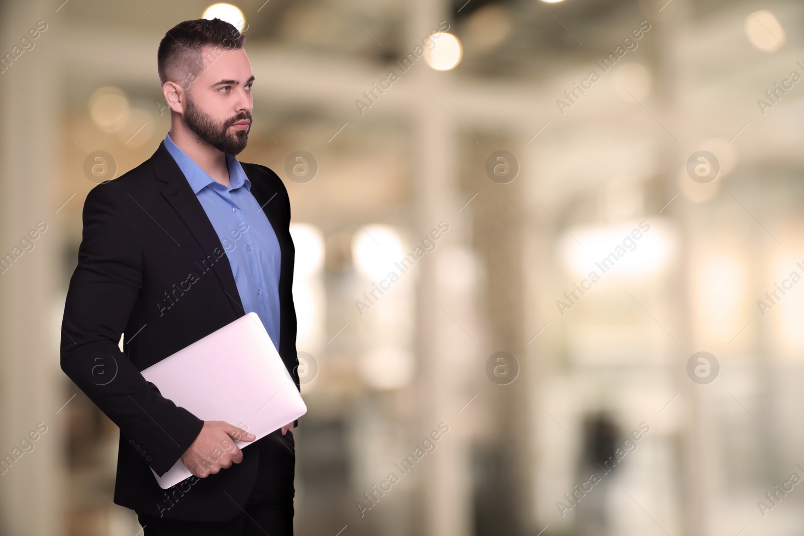 Image of Successful lawyer with laptop on blurred background, space for text