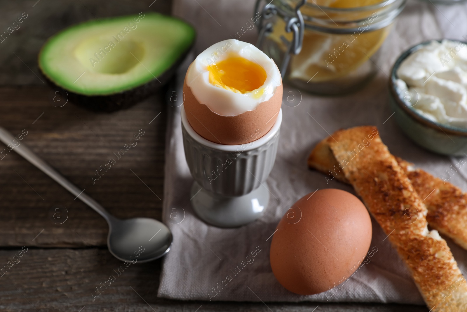 Photo of Soft boiled egg served for breakfast on wooden table