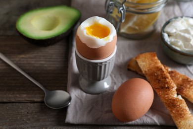 Soft boiled egg served for breakfast on wooden table