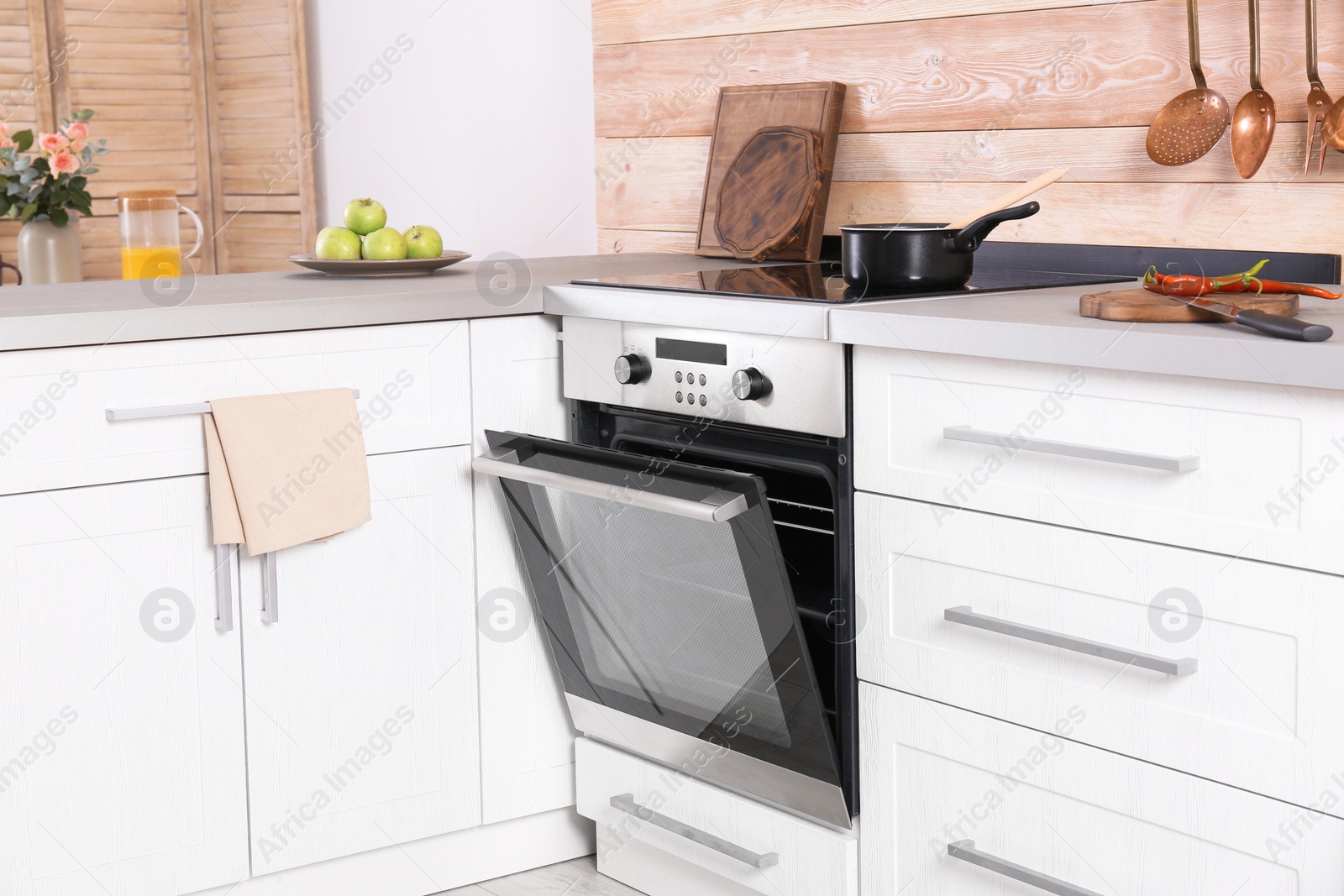 Photo of Light modern kitchen interior with new oven