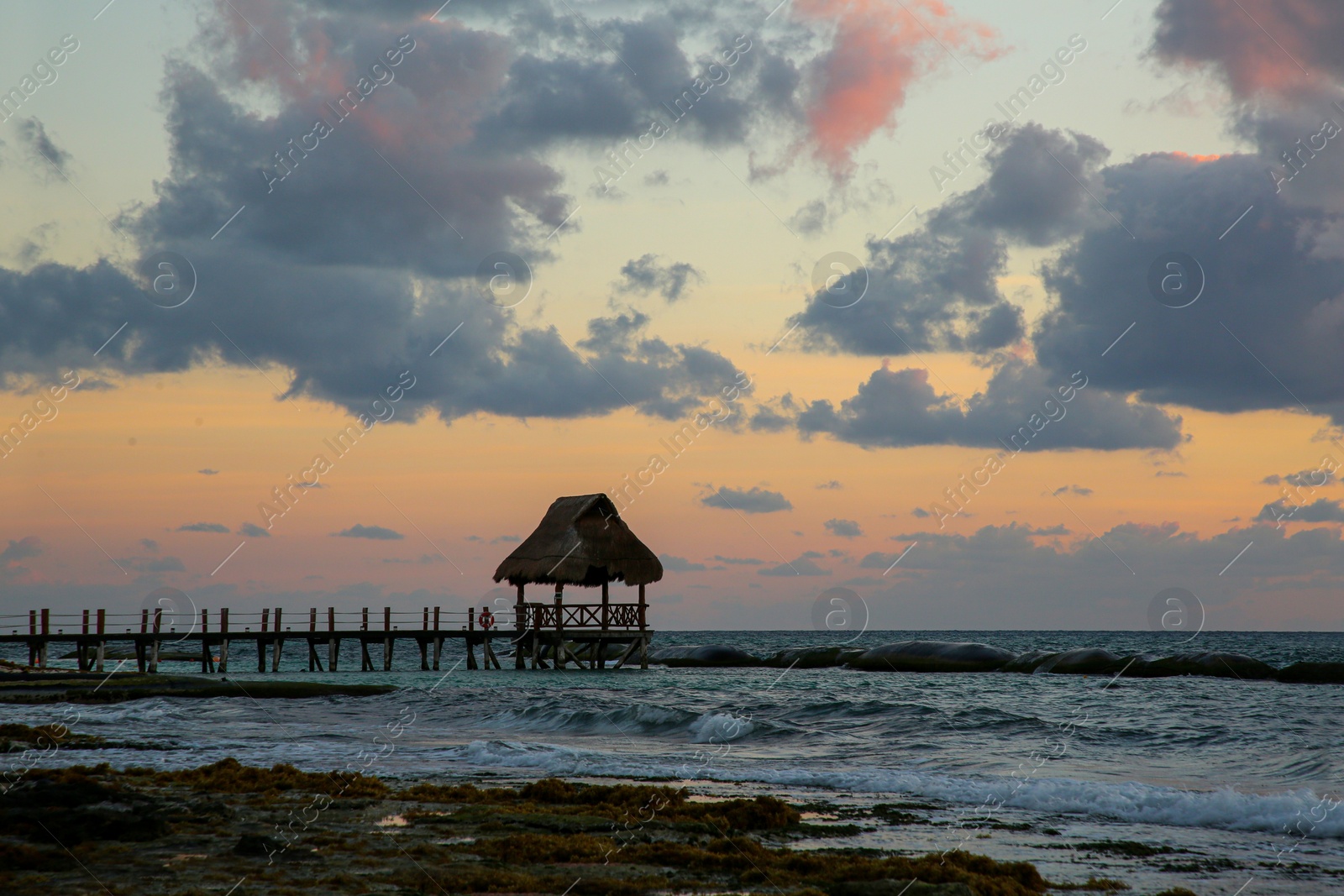 Photo of Picturesque view of sea and wooden pier at beautiful sunset