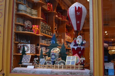 Paris, France - December 10, 2022: Store display with different boxes and Christmas decor