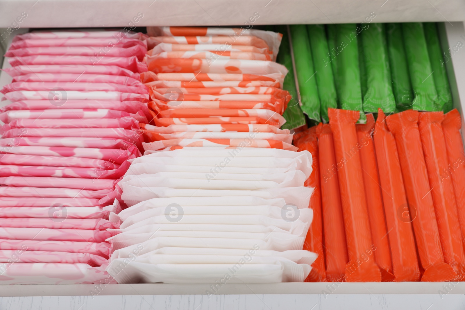 Photo of Storage of different feminine hygiene products in drawer, closeup