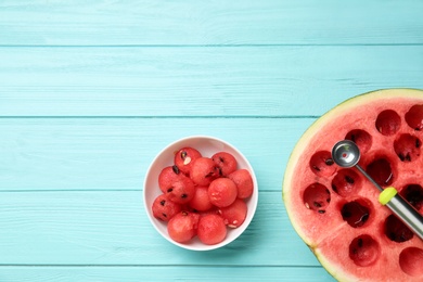 Flat lay composition with watermelon balls on light blue wooden background, space for text