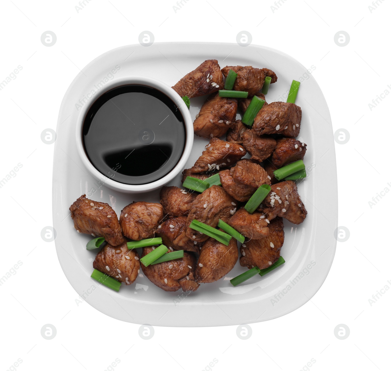 Photo of Plate with tasty soy sauce, roasted meat, sesame and green onion isolated on white, top view