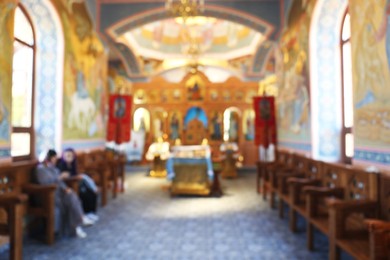 Photo of Blurred view of beautiful church interior with ecclesiastical icons