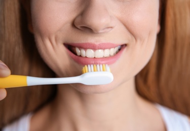 Photo of Smiling woman with toothbrush, closeup. Dental care