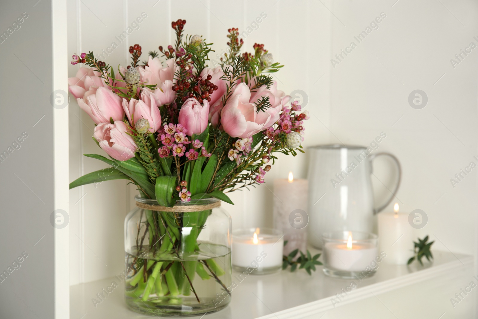 Photo of Beautiful bouquet with spring pink tulips on shelf