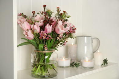 Photo of Beautiful bouquet with spring pink tulips on shelf