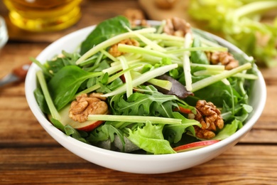 Delicious fresh celery salad on wooden table, closeup