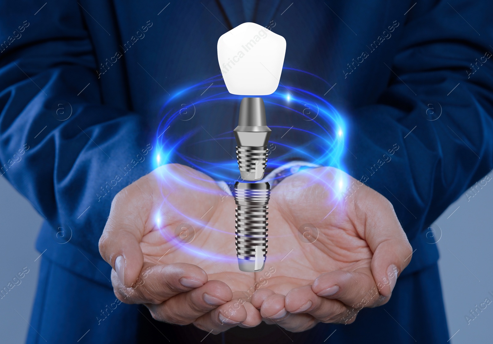 Image of Man demonstrating dental implant on light background, closeup