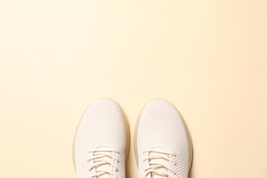 Photo of Pair of stylish sport shoes on beige background, flat lay. Space for text