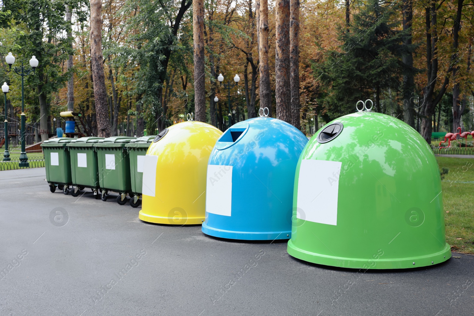 Photo of Waste sorting bins in park on autumn day