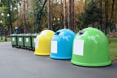 Photo of Waste sorting bins in park on autumn day