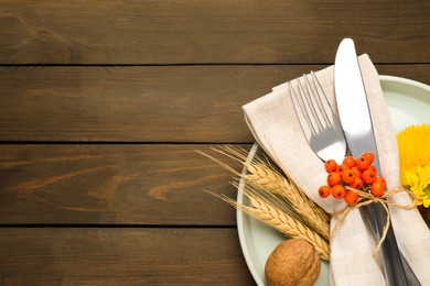 Top view of seasonal table setting with autumn items on wooden background, space for text. Thanksgiving Day