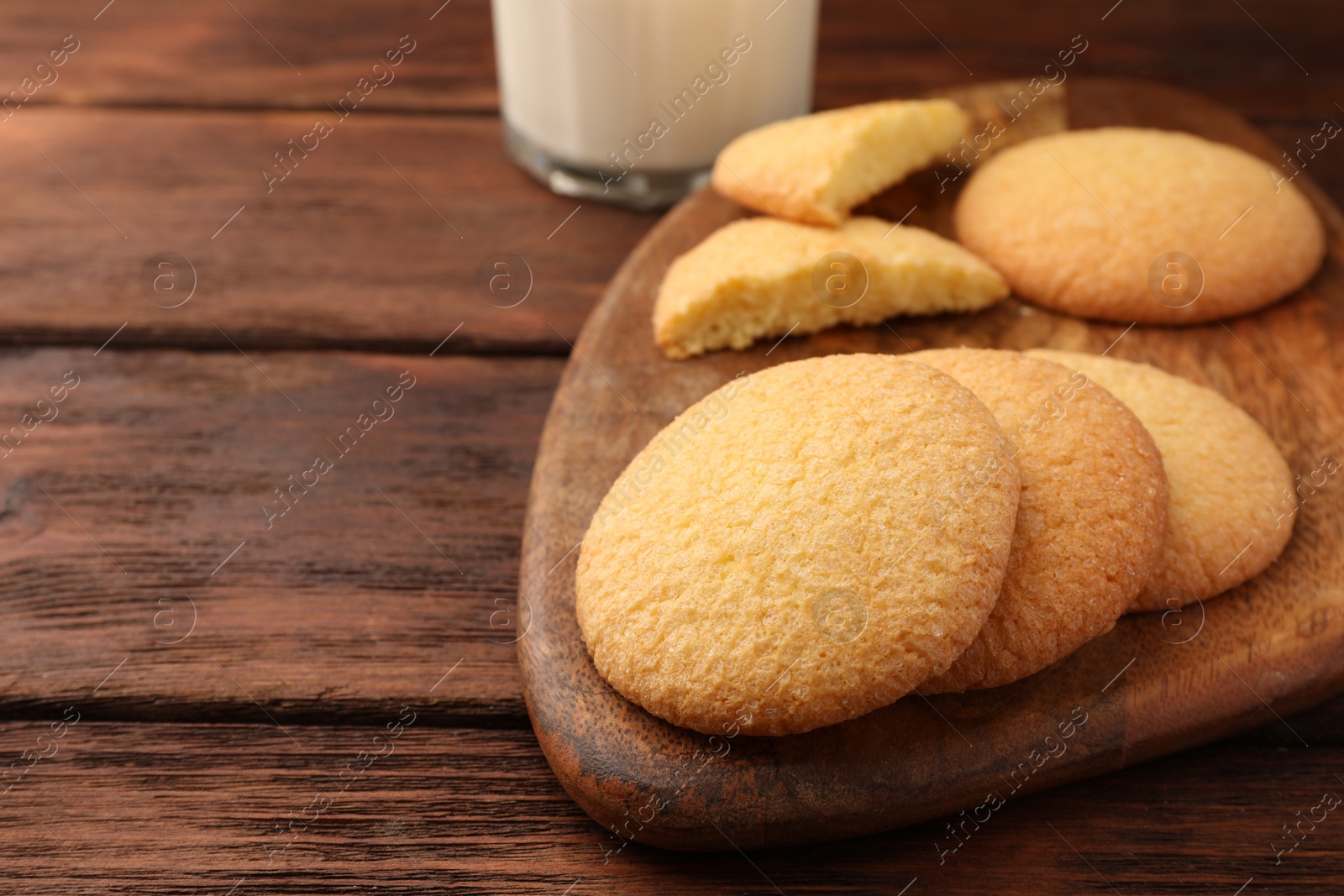 Photo of Delicious Danish butter cookies on wooden table, closeup. Space for text