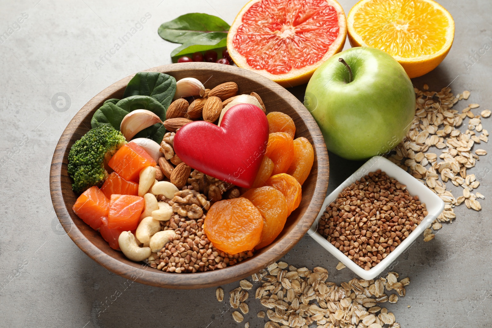 Photo of Composition with heart-healthy products on grey background