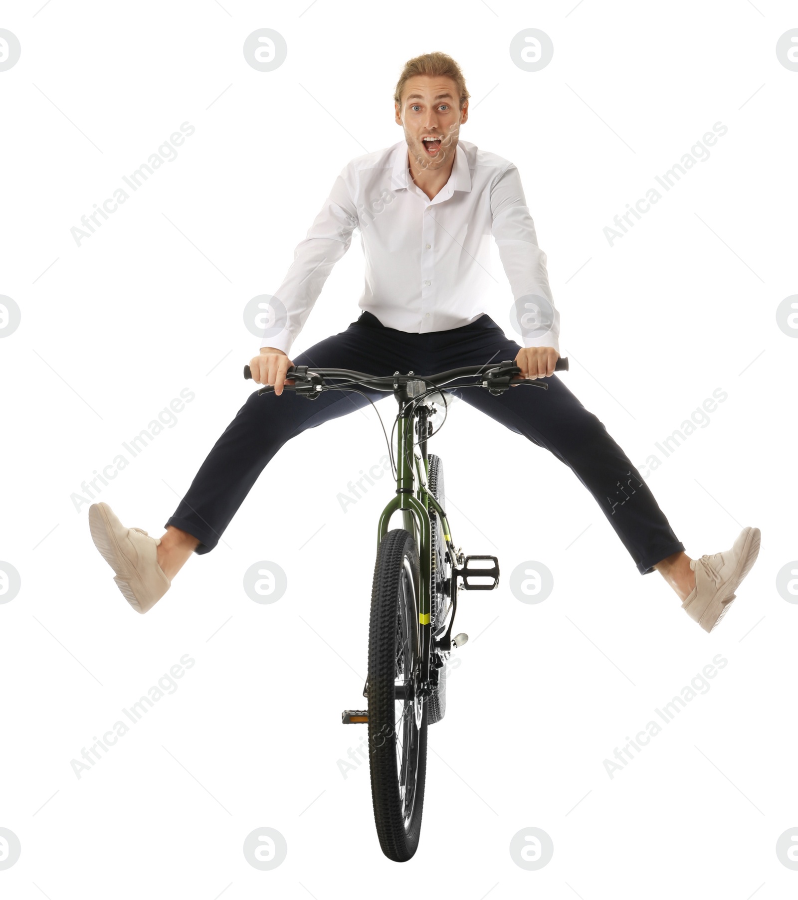 Photo of Excited young man riding bicycle on white background