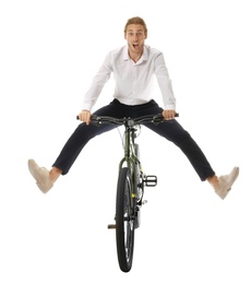 Photo of Excited young man riding bicycle on white background