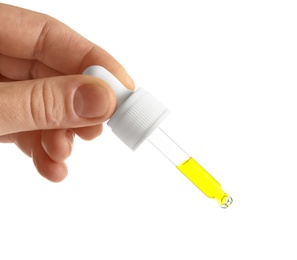 Photo of Woman holding pipette with oil on white background