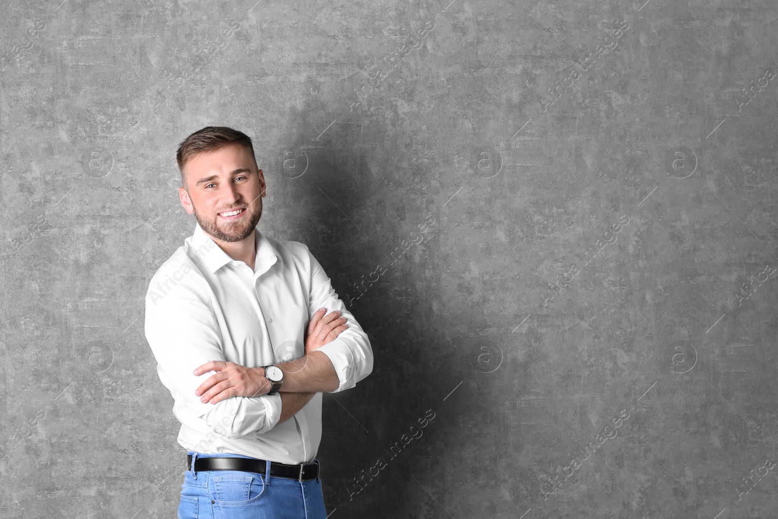 Photo of Portrait of handsome happy man on grey background, space for text