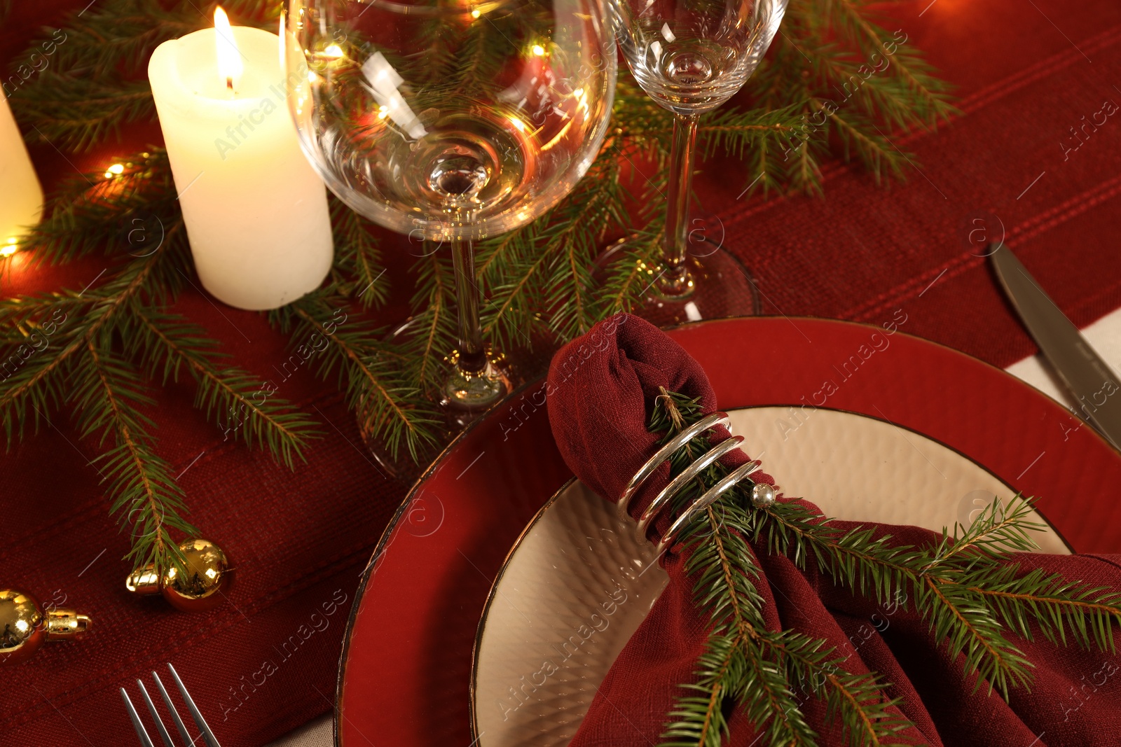 Photo of Christmas place setting with festive decor on table, closeup