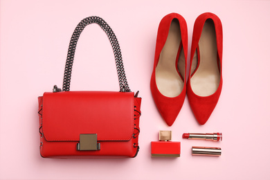 Photo of Flat lay composition with stylish woman's bag and accessories on pink background