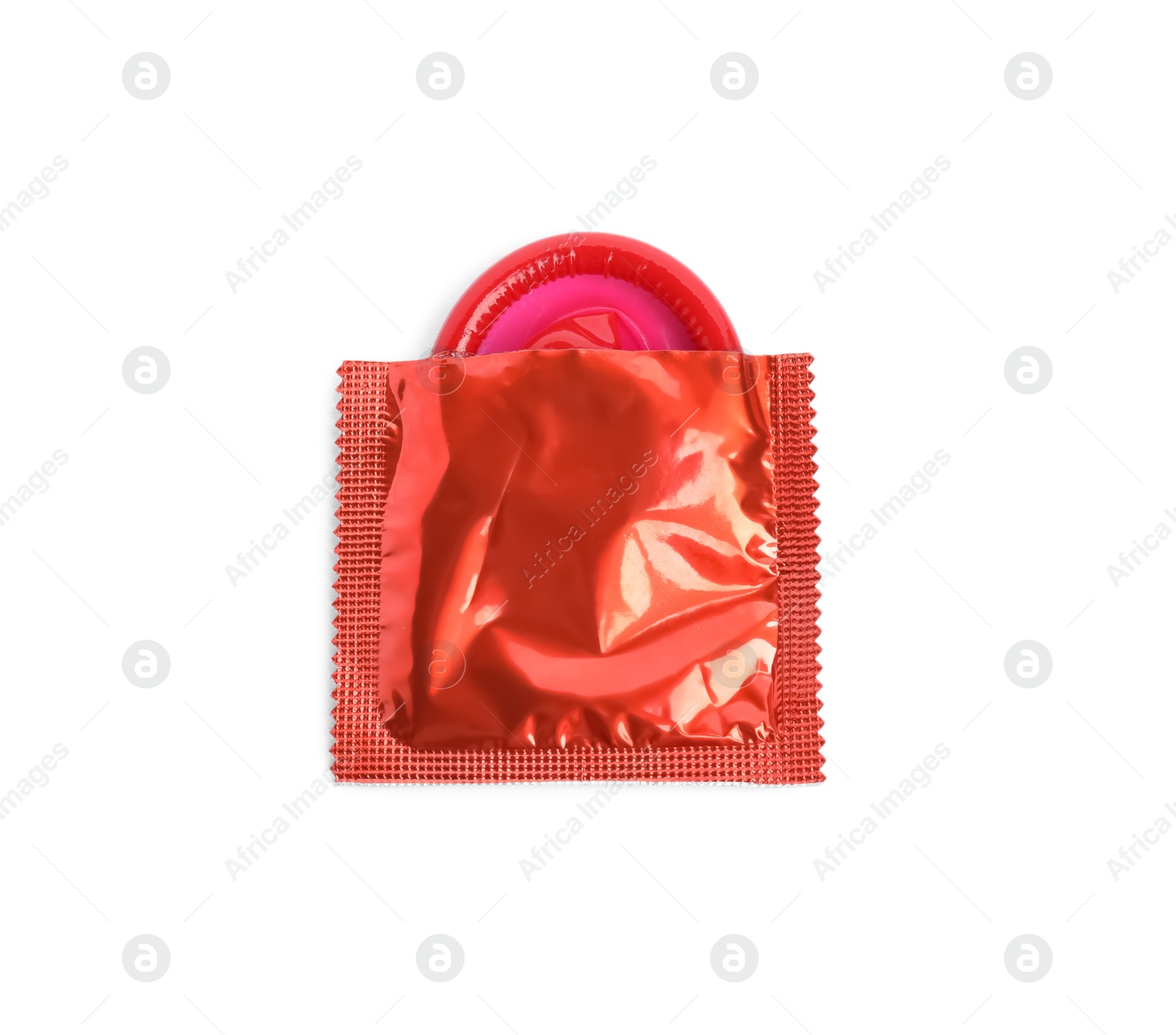 Photo of Unpacked red condom isolated on white, top view. Safe sex