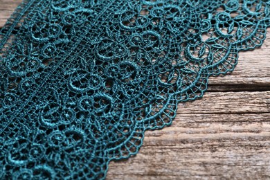 Photo of Beautiful lace on wooden table, above view