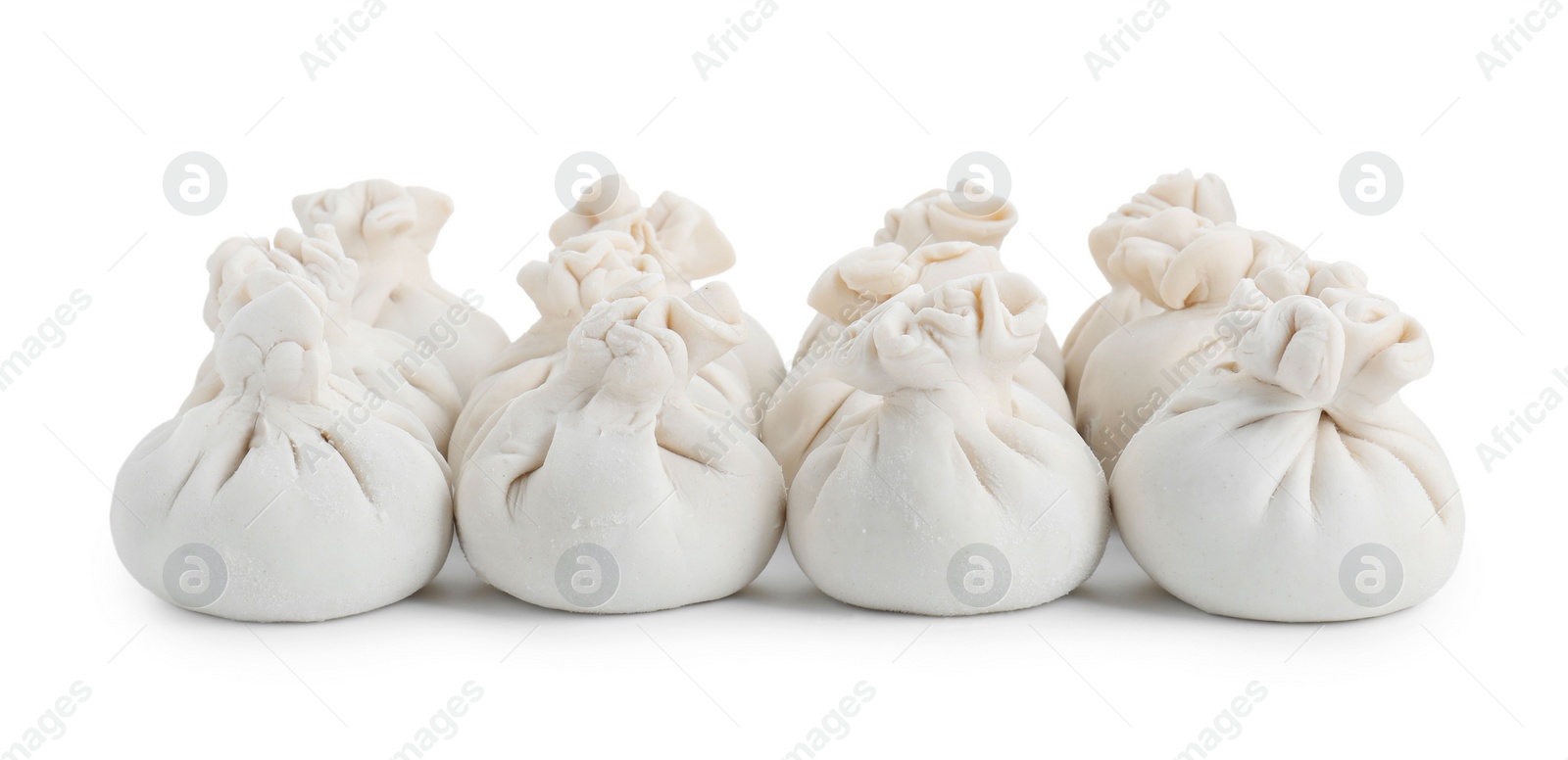 Photo of Many uncooked khinkali (dumplings) isolated on white. Georgian cuisine