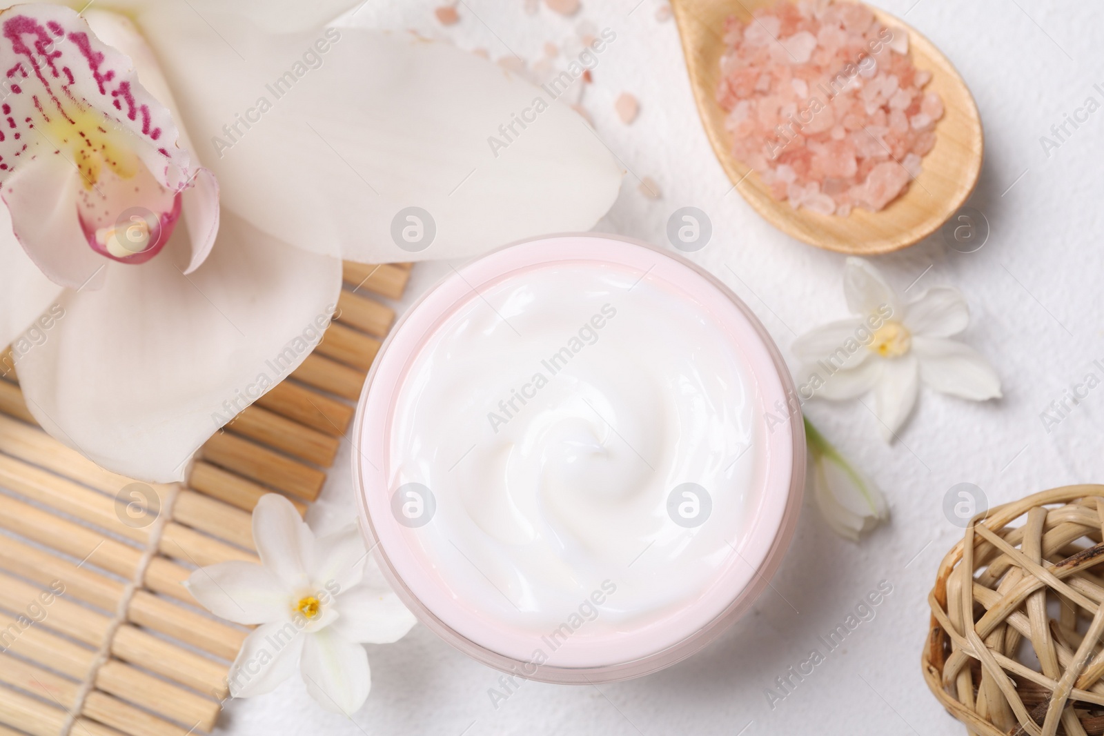 Photo of Beautiful spa composition with cosmetic products and flowers on white table, flat lay