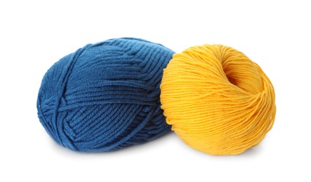 Blue and yellow balls of woolen knitting yarns on white background