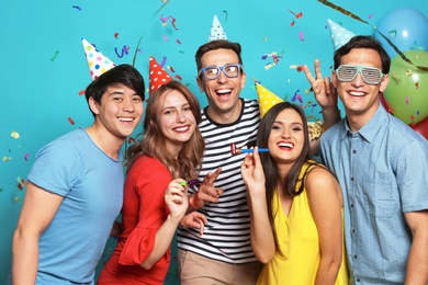 Photo of Happy young people celebrating birthday together on color background