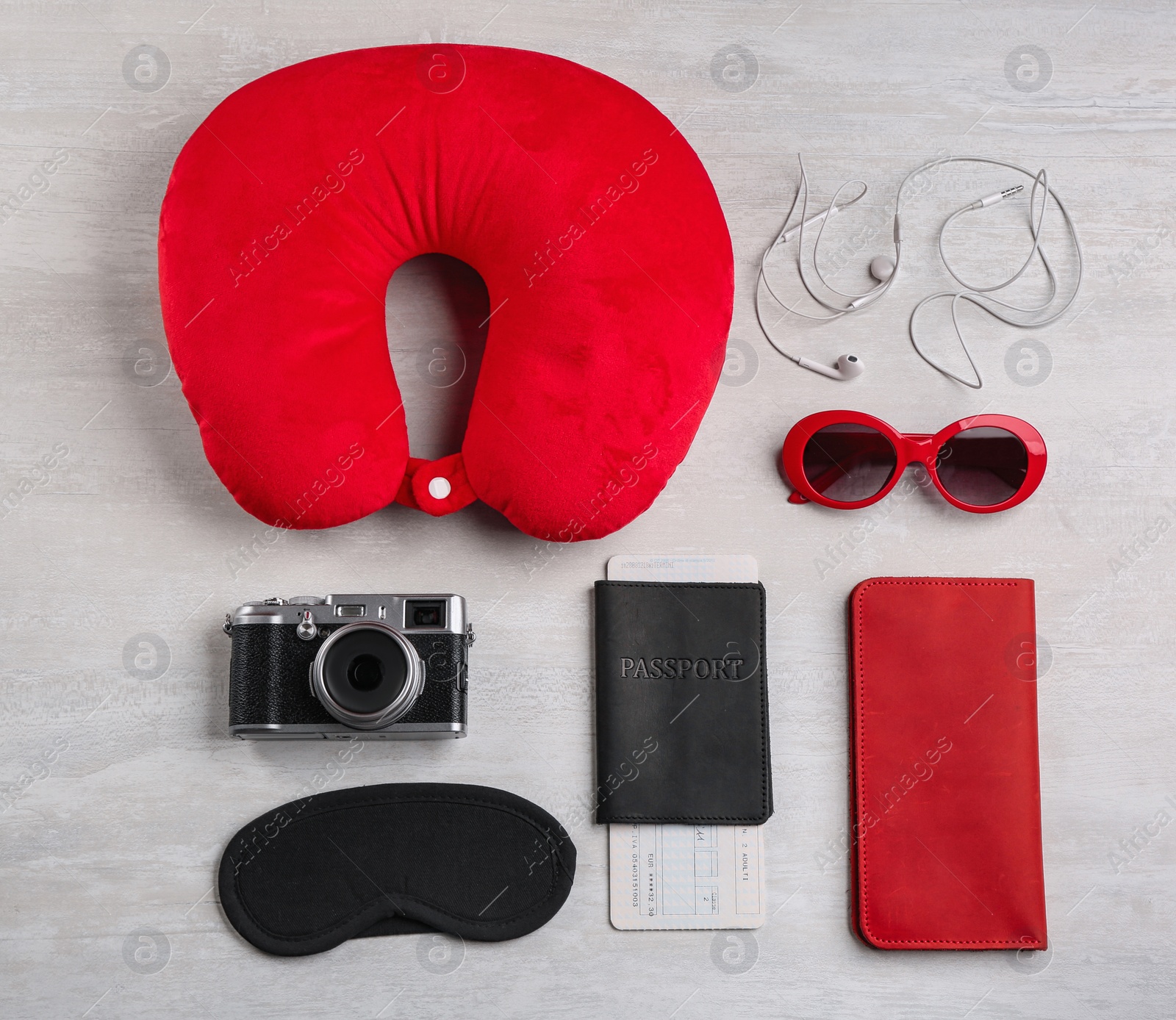 Image of Flat lay composition with red travel pillow on light background