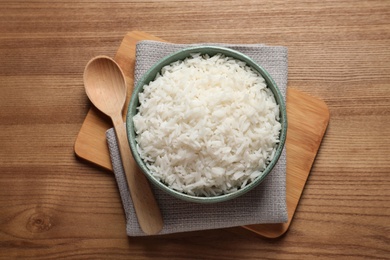Photo of Bowl of tasty cooked rice served on table, flat lay