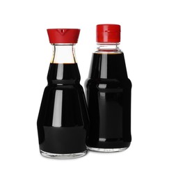 Bottles of tasty soy sauce isolated on white