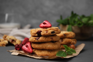 Photo of Cookies with freeze dried fruits and mint on grey table, closeup