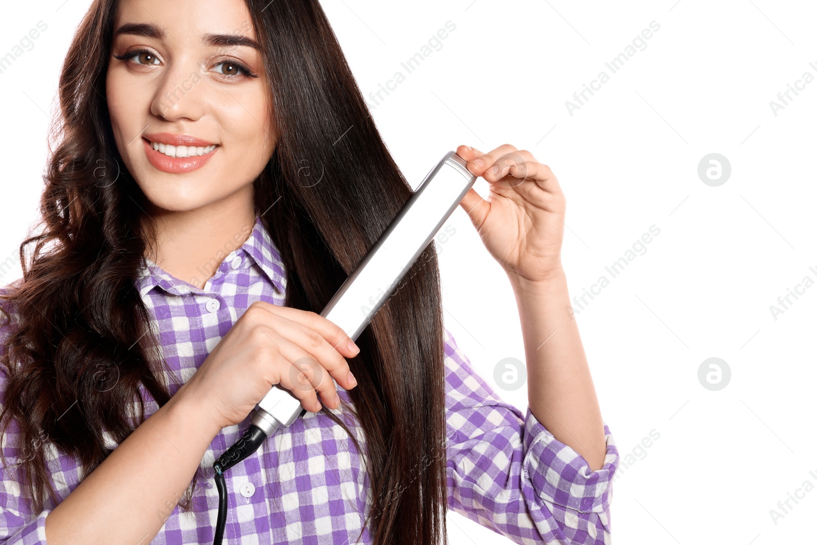 Photo of Happy woman using hair iron on white background