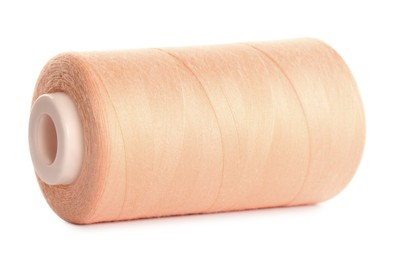 Photo of Spool of pale pink sewing thread isolated on white
